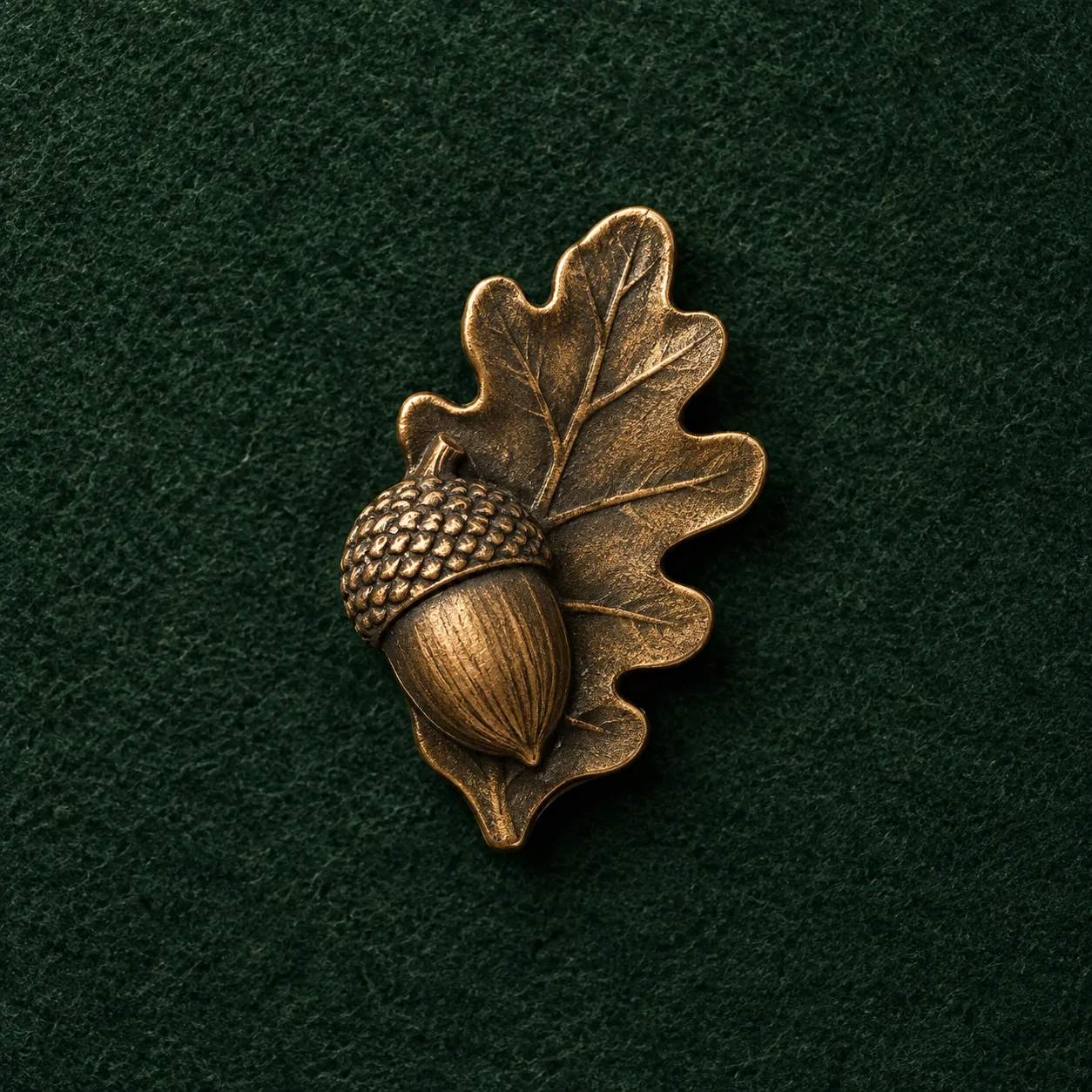 Acorn and Leaf Lapel Pin, front view on green felt