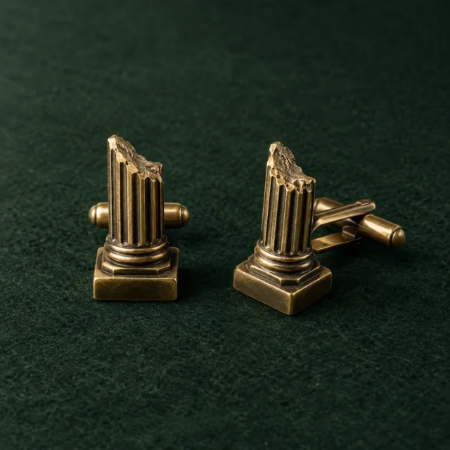 Broken Column Cufflinks, front view on green felt