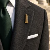 Broken Column Lapel Pin worn with a wedding suit