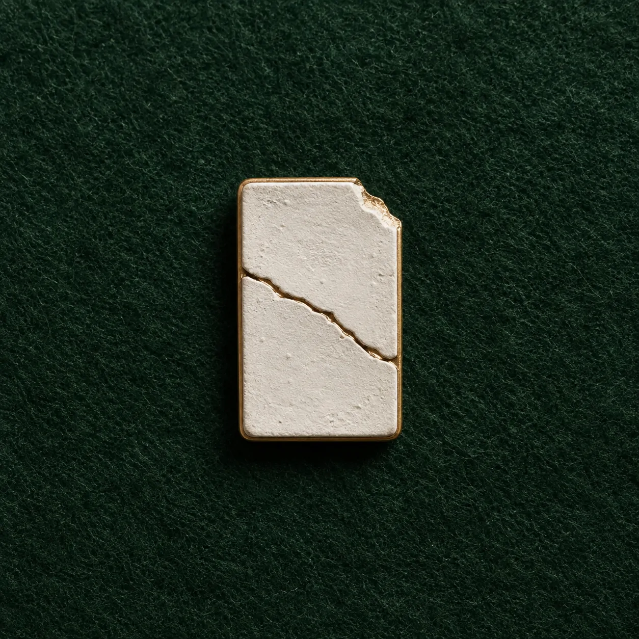Cracked Tablet Lapel Pin, front view on green felt