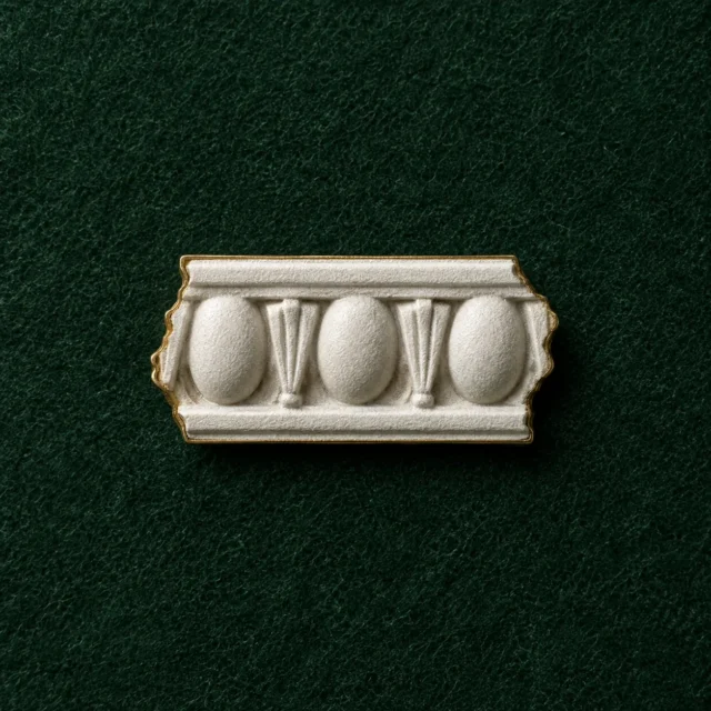 Egg and Dart Lapel Pin, front view on green felt
