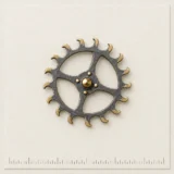 Escapement Wheel Lapel Pin on a millimetre scale card