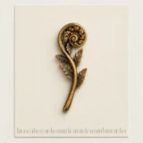 Fern Crozier Lapel Pin on a millimetre scale card