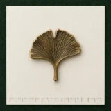 Ginkgo Leaf Lapel Pin on a millimetre scale card