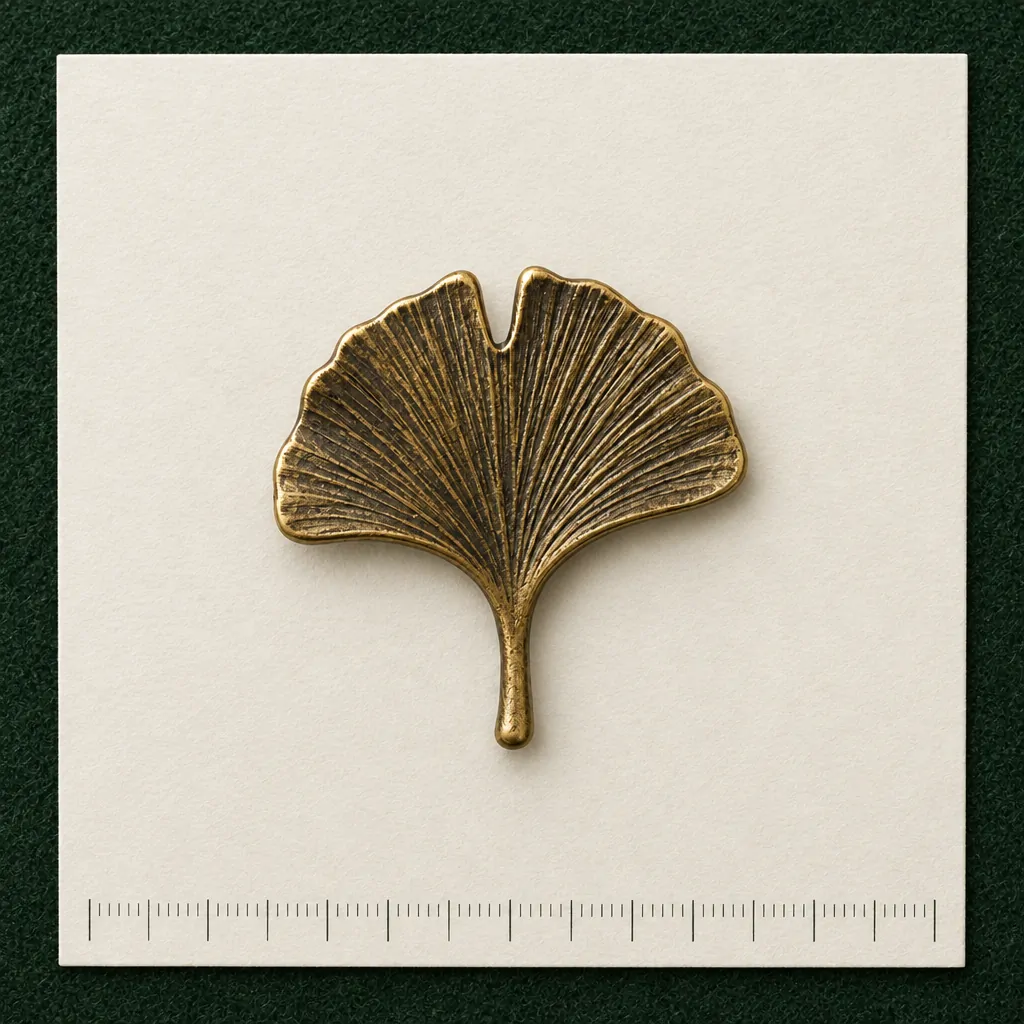 Ginkgo Leaf Lapel Pin on a millimetre scale card