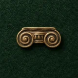Ionic Volute Lapel Pin, front view on green felt