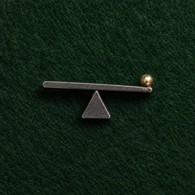 Lever and Fulcrum Lapel Pin, front view on green felt