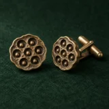 Lotus Pod Cufflinks, front view on green felt