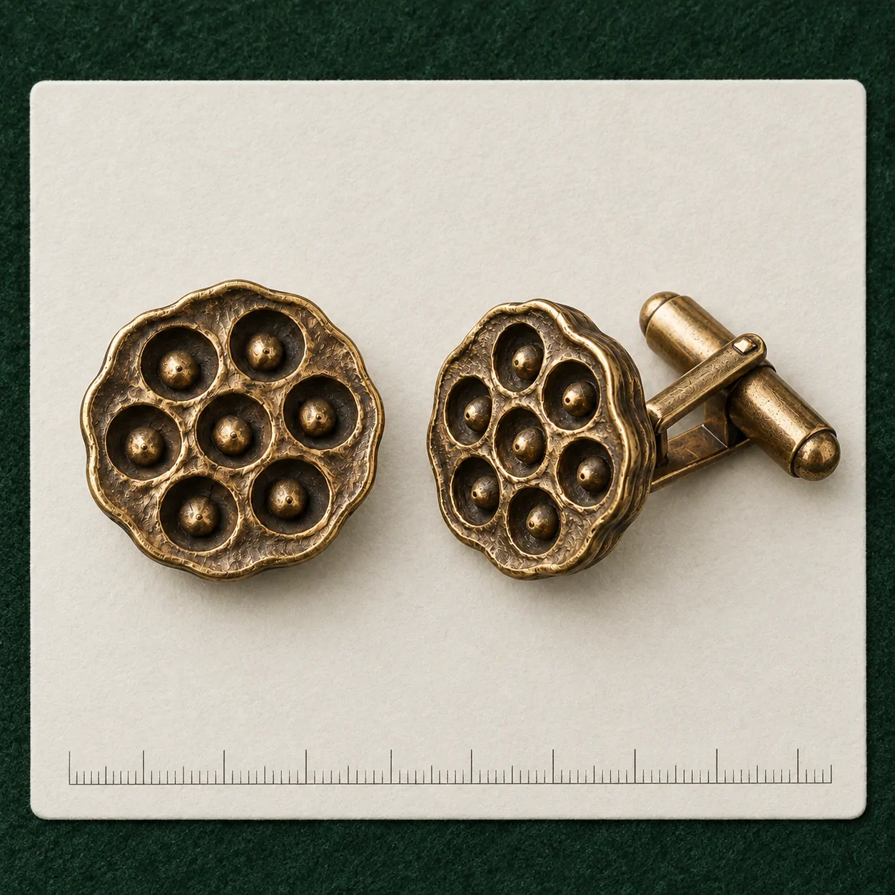Lotus Pod Cufflinks on a millimetre scale card