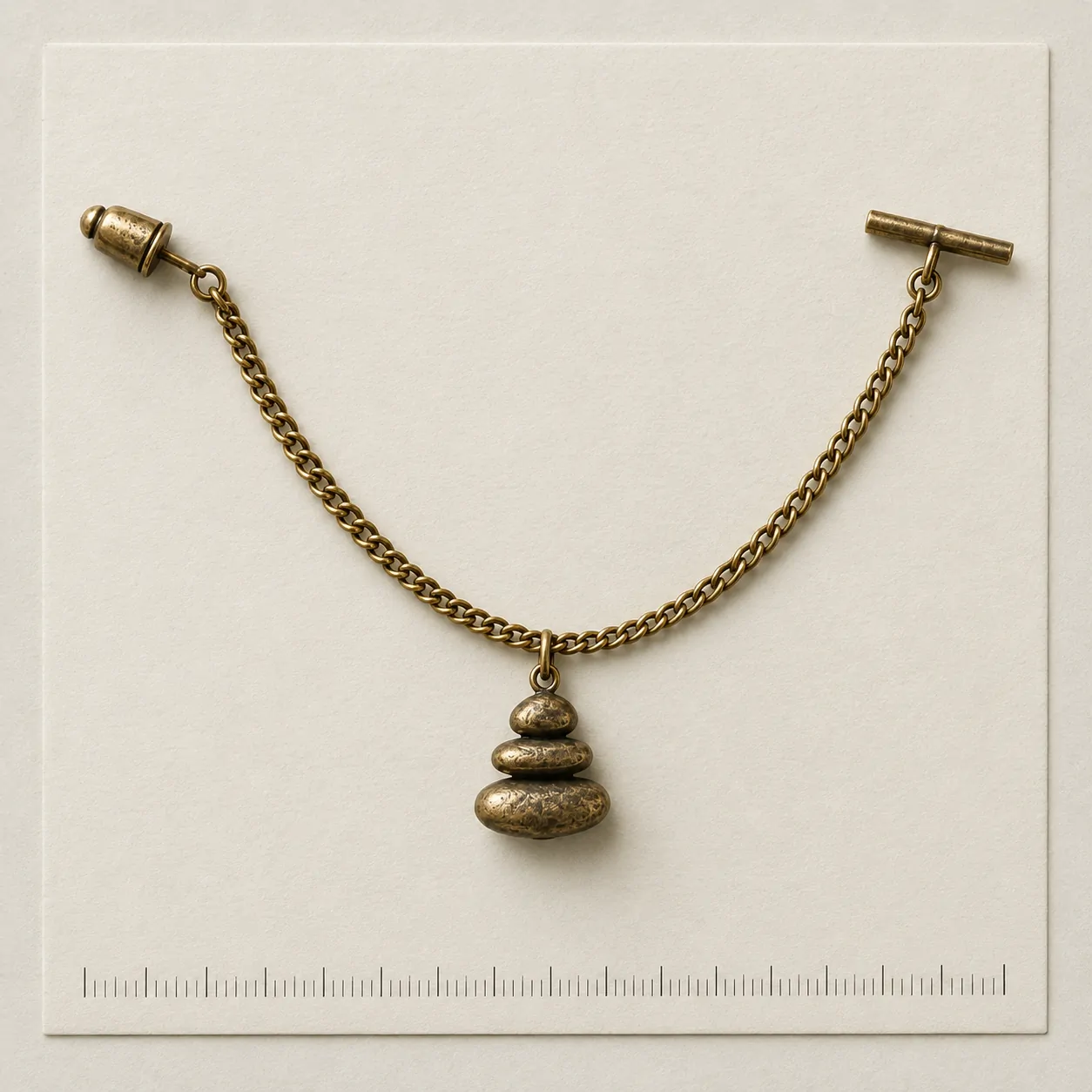 Pebble Cairn Lapel Chain on a millimetre scale card