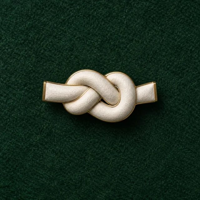 Cast Knot Lapel Pin, front view on green felt