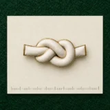 Cast Knot Lapel Pin on a millimetre scale card