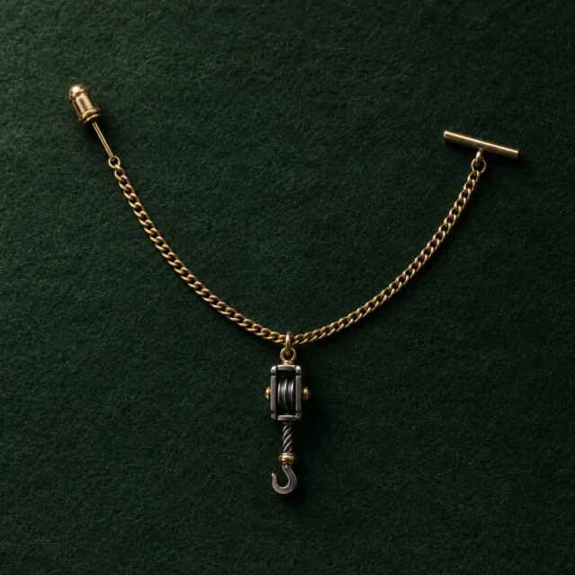 Pulley Block Lapel Chain, front view on green felt