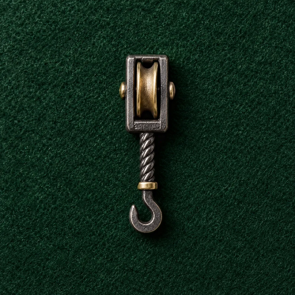 Pulley Block Lapel Pin, front view on green felt