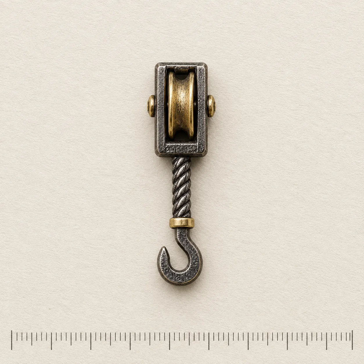 Pulley Block Lapel Pin on a millimetre scale card