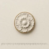 Ceiling Rosette Lapel Pin on a millimetre scale card